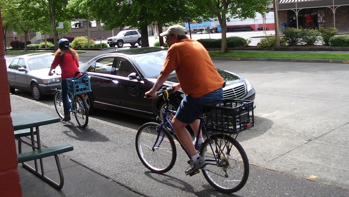 A couple riding two millk crate bikes