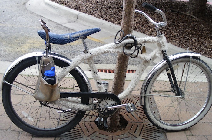 Bicycle covered in fur with carpenter belt pannier