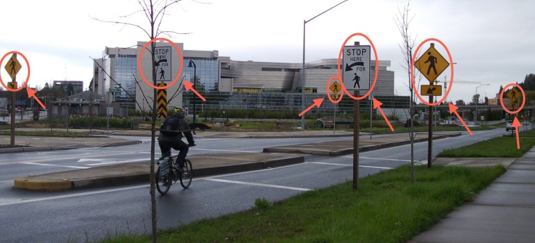 Heavily signed pedestrian crossing by the new Morse federal courthouse in Eugene