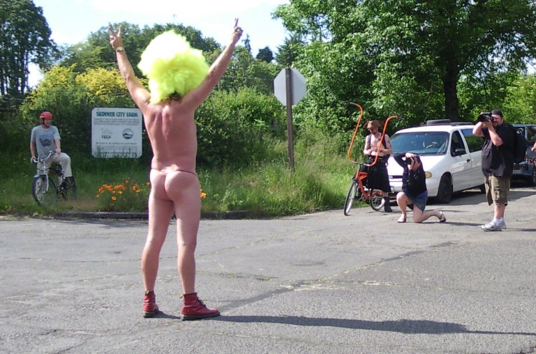 Man in outrageous wig at the World Naked Bike Ride Eugene