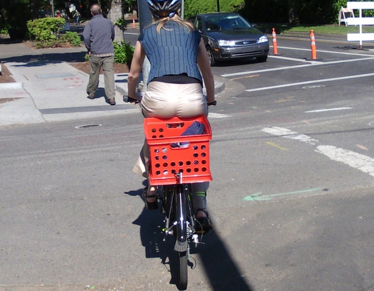 Heading for the finish line on 13th Avenue Buns hanging over into a bicycle mounted milk crate
