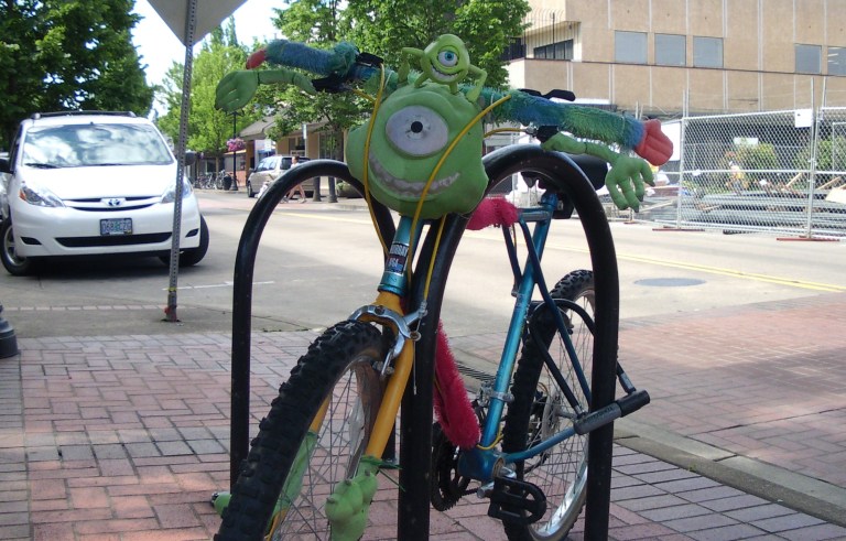A bicycle decorated with character from the movie Monsters Inc.