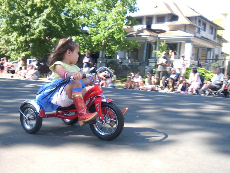 Photo of a girl on a tricycle in the Eugene Celebration Parade