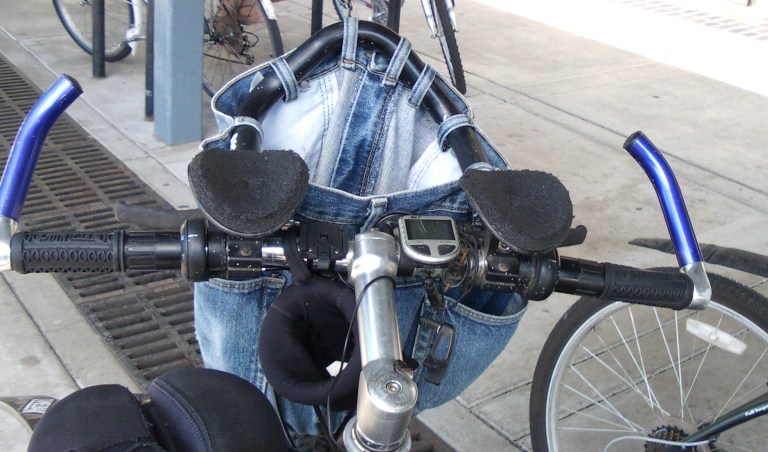 Shows a bicycle handlebar bag made from repurposed jeans and aerobars