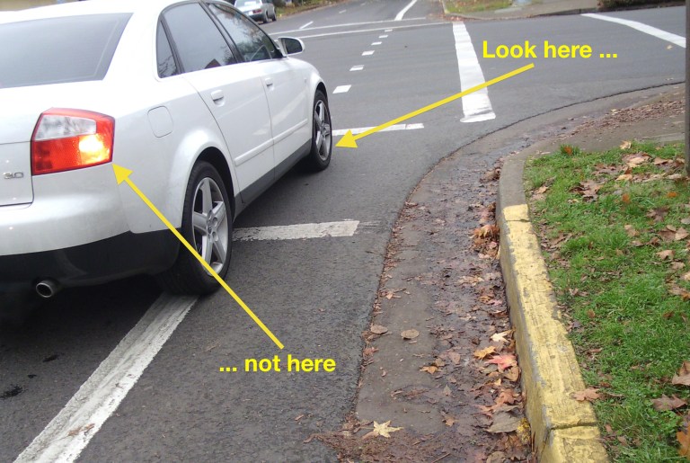 Car looks as thought it might turn right, so look at the front wheel to know what's happening, not the turn signal